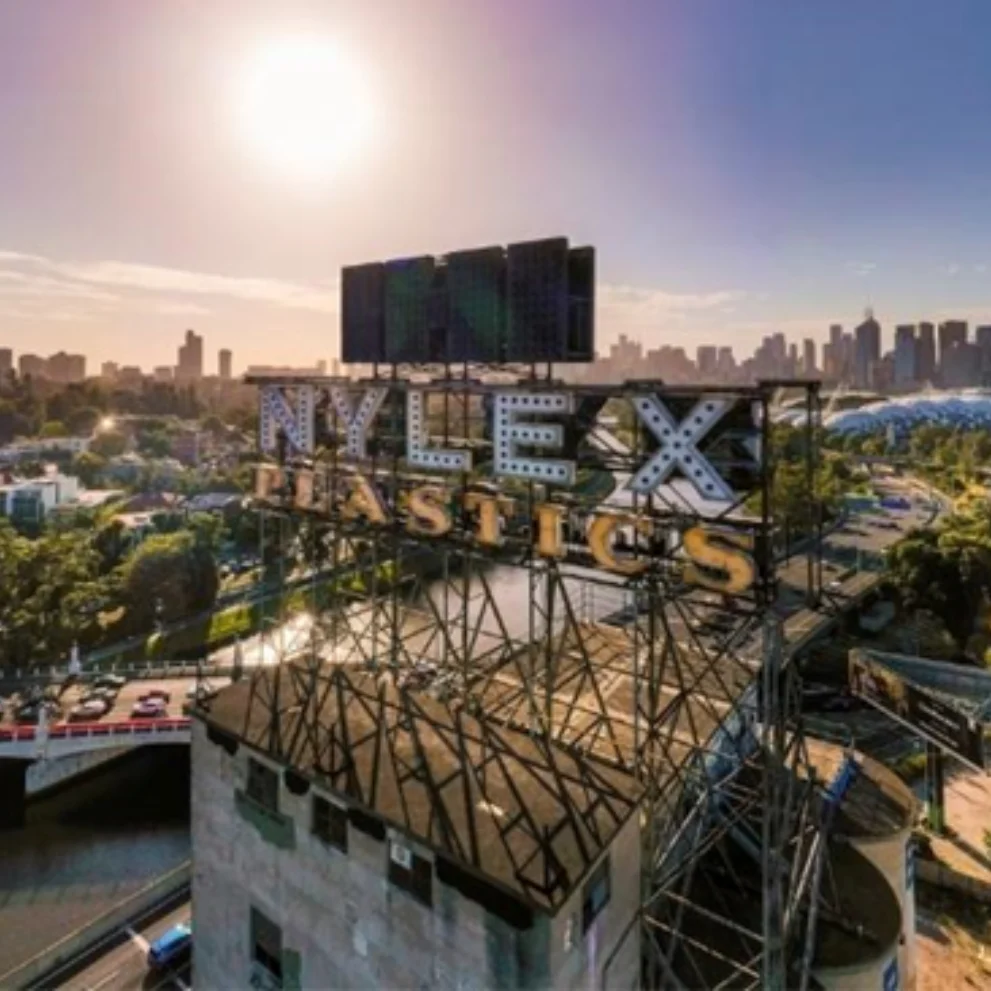 Nylex Clock against city skyline